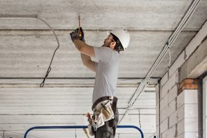 An Xtreme Home Improvement technician in the process of restoring a ceiling